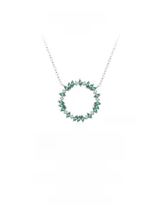 Detail of 925 sterling silver wreath pendant with green emeralds and pavé diamonds