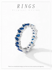 Macro shot of 925 silver ring featuring marquise blue gems and sparkling pave diamonds