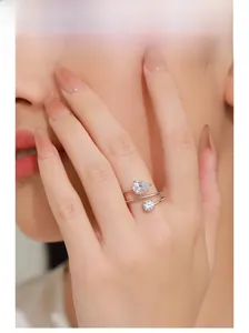 Detail of S925 silver wrap ring with teardrop and round cubic zirconia on finger