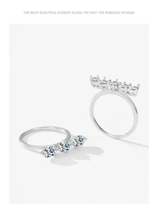 Détail de bagues empilables en argent serties de pierres taille marquise sur fond blanc
