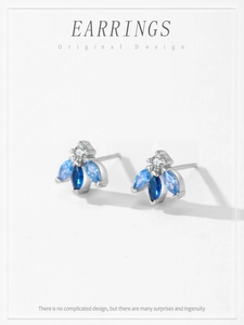 Detail of 925 silver bee earrings with blue gradient stones and white zircon