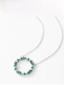 Detail of 925 sterling silver wreath pendant with marquise emeralds and diamonds