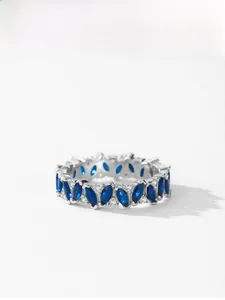 Macro view of 925 silver ring featuring blue marquise-cut stones and micropavé diamonds
