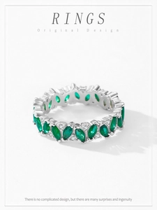 Macro view of marquise cut green zircon and pavé diamonds on a silver ring