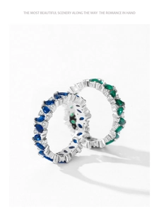 Detail of 925 silver rings featuring blue and green oval-cut stones in a stacked layout