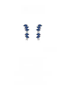 Macro shot of silver stud earrings featuring marquise-cut blue zircon in a curved design
