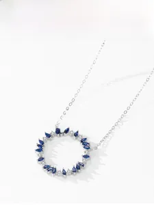 Détail du pendentif soleil en argent avec pierres bleues marquises et cristaux brillants