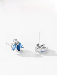 Detailed close-up of 925 sterling silver bee stud earrings with blue gradient stones