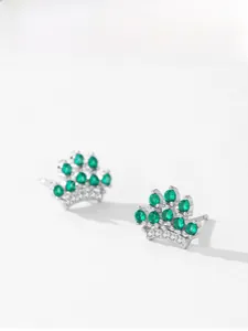 Detailed close-up of crown earrings featuring green zircon stones and 925 silver setting