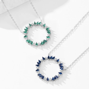 925 silver wreath necklace with emerald and blue gemstones in a circular diamond design