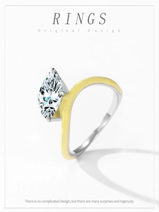 Macro shot of marquise-cut diamond ring featuring a vibrant yellow enamel silver band