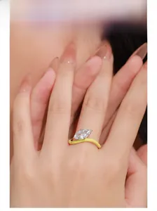 Marquise-cut zircon ring on finger featuring a wavy yellow enamel band design