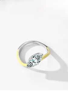 Top view of a silver marquise-cut diamond ring featuring yellow enamel accents on the band