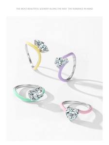 Detailed macro of silver rings with colorful enamel and marquise-cut sparkling zircon stones