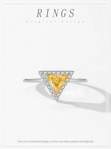 Macro detail of triangle yellow gemstone ring set in S925 sterling silver band