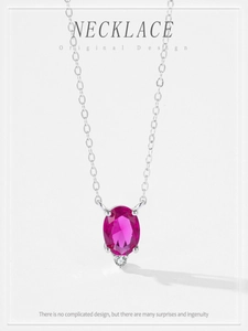 Detail of 925 sterling silver necklace with oval ruby red zircon and delicate chain