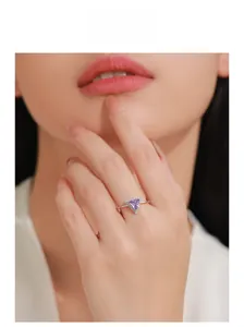 Makroansicht eines S925 Silberrings mit dreieckigem Amethyst am Finger eines Models