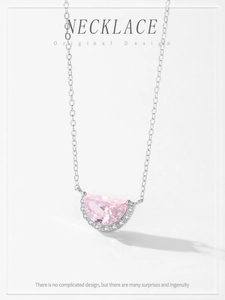 Macro detail of S925 silver necklace with pink crescent pendant and micro-pave zircons