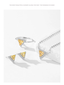 Detail of 925 sterling silver set with triangular yellow gemstones and zircon pavé