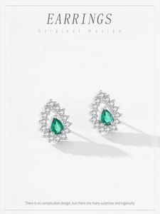 Detail of pear-shaped green crystal stud earrings in 925 sterling silver setting