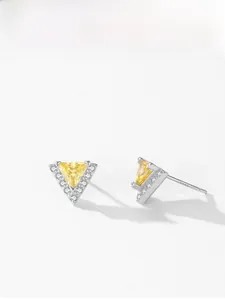 Macro detail of triangle silver stud earrings with yellow gemstone and S925 hallmark