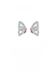 Macro detail of silver butterfly wing earrings with pink gemstones and white zircons