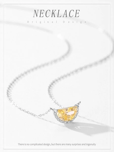 Detail of S925 silver necklace with half-moon yellow gemstone and pavé zirconia stones