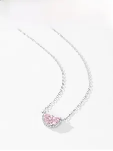 Detail of S925 silver necklace with pink half-moon gemstone pendant and diamond accents