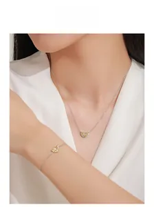 Model wearing a 925 sterling silver necklace and bracelet set with half-moon yellow stones