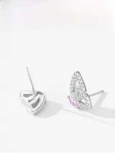 Macro detail of S925 sterling silver butterfly earrings with pink gemstones and crystals