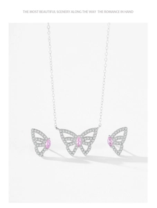 Macro detail of silver butterfly earrings and necklace set with pink marquise stones