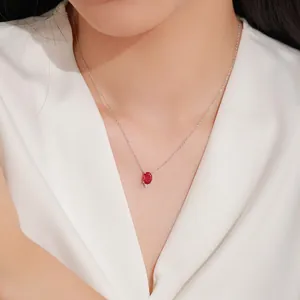 Elegant 925 sterling silver necklace with oval red garnet pendant on model's neckline