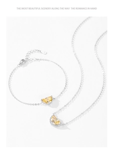 Macro detail of S925 silver jewelry set featuring yellow crescent stones and pavé zircons