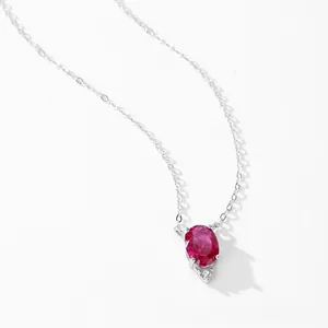 925 silver necklace featuring an oval garnet pendant and small sparkling diamond accent