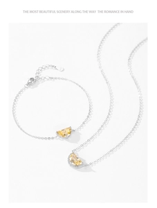 Macro shot of S925 silver necklace and bracelet set with yellow citrine moon pendants