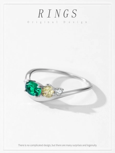Close-up of S925 silver ring featuring emerald cut green zircon and three-stone setting