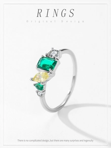 Detail of 925 silver ring featuring geometric green and yellow zircon stones setting
