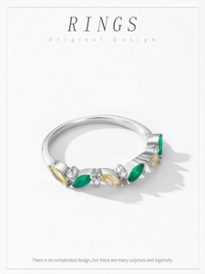 Macro detail of leaf-shaped green and yellow zircons on S925 sterling silver ring