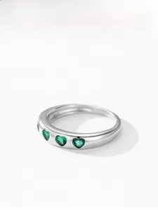 Detailed view of S925 sterling silver ring with three green heart-cut emerald zircons