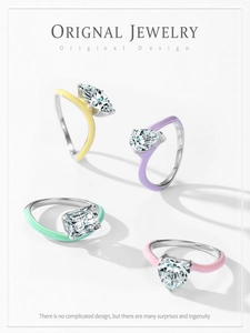 Detailed macro of four pastel enamel silver rings with marquise and heart cut stones
