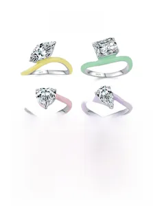 Detail of four S925 silver rings with colorful enamel and assorted gemstone shapes