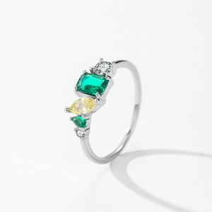 925 silver geometric ring with emerald green and yellow zircon stones on white background