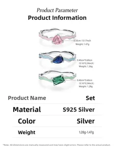 Detailed macro view of S925 sterling silver rings with pink heart and green rectangle gems