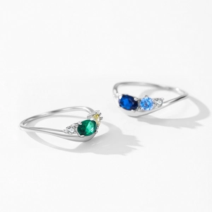 S925 sterling silver ring with emerald, yellow and blue zircons on a white background