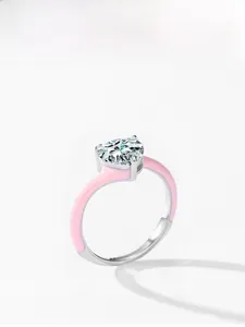 Detail of a 925 silver heart-shaped faux diamond ring with pink enamel band design