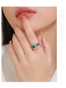 Detailed close-up of a model wearing three stacked 925 silver rings with colorful enamel