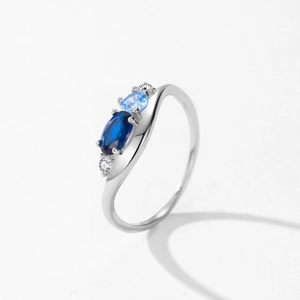 Elegant S925 silver wavy ring featuring asymmetric blue sapphires and white cubic zirconia