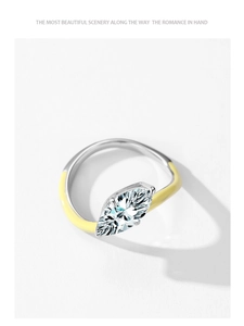 Detailed close-up of marquise-cut crystal ring with silver and yellow enamel finish