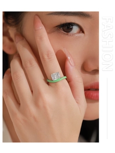 Detail of wavy green enamel ring with large square cubic zirconia on model finger