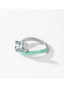 Close-up of silver ring featuring mint green enamel and a large radiant cut cubic zirconia